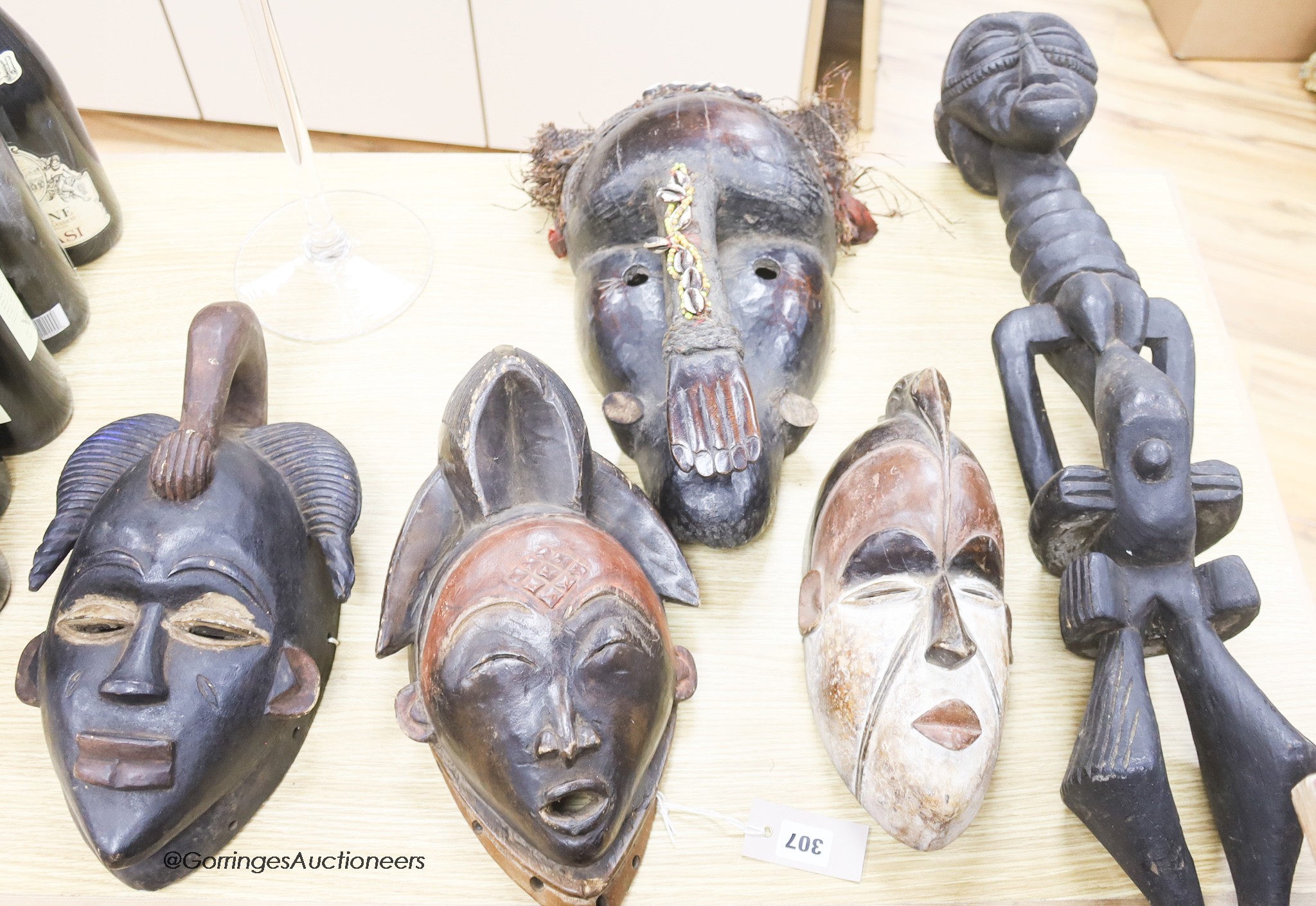 Tribal carvings including carved tribal masks and a figure, tallest 84cm